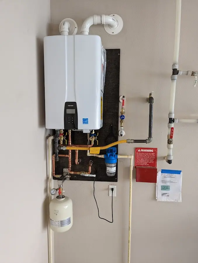 Professional plumber installing copper piping in a Concordia home